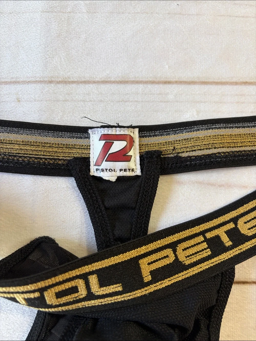 Pistol Pete Men's Black Mesh Thong with Gold Waistband